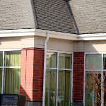 Closer view of the Hilton garden inn's gutter and downspout aligning with windows