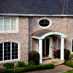 Residential home with a curved sheet metal entryway thumbnail